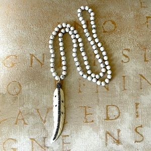 Howlet beaded necklace with carved bone feather pendant with rhinestones